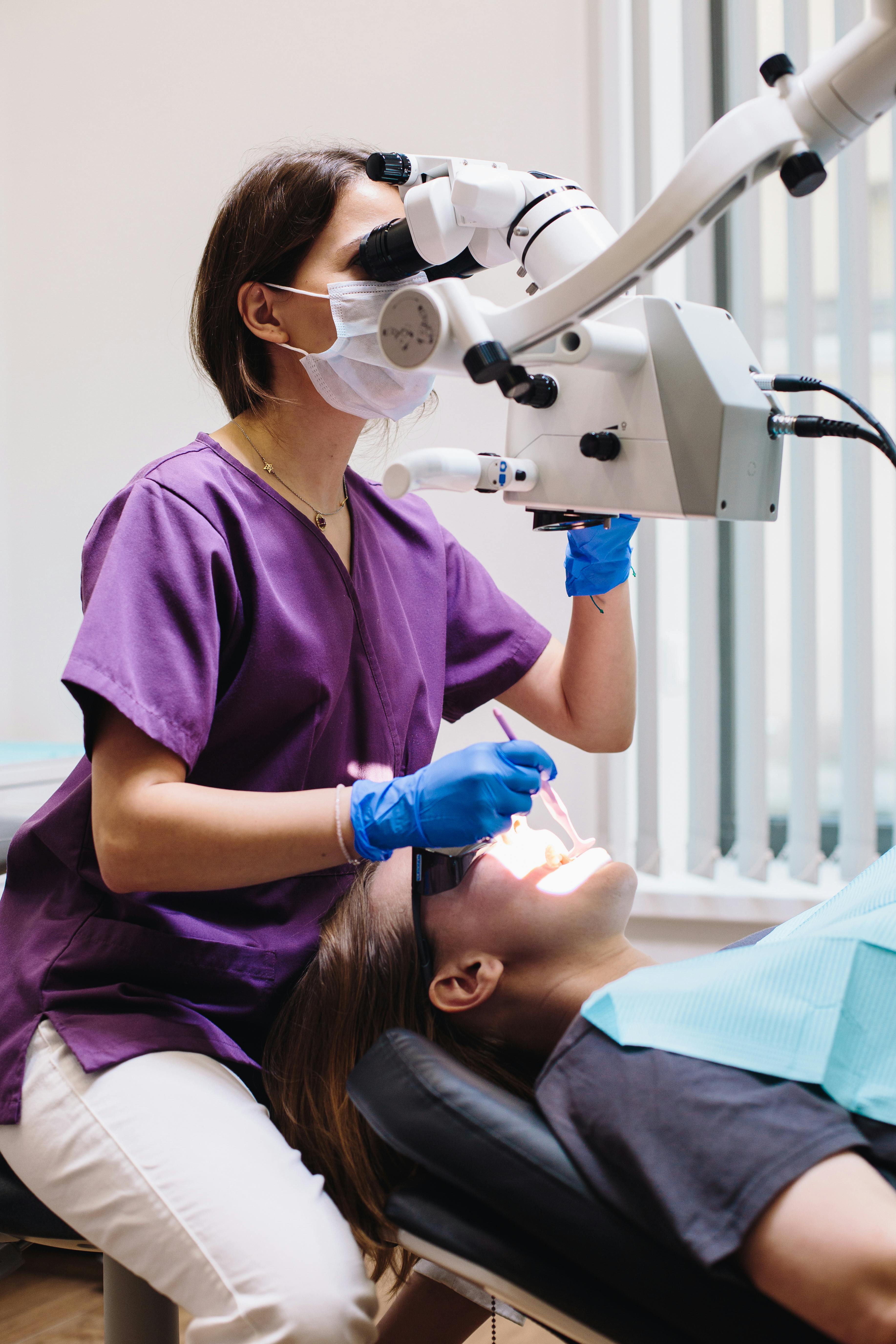 A dentist guides a smiling patient through a check-up at Wisteria House Dental Practice